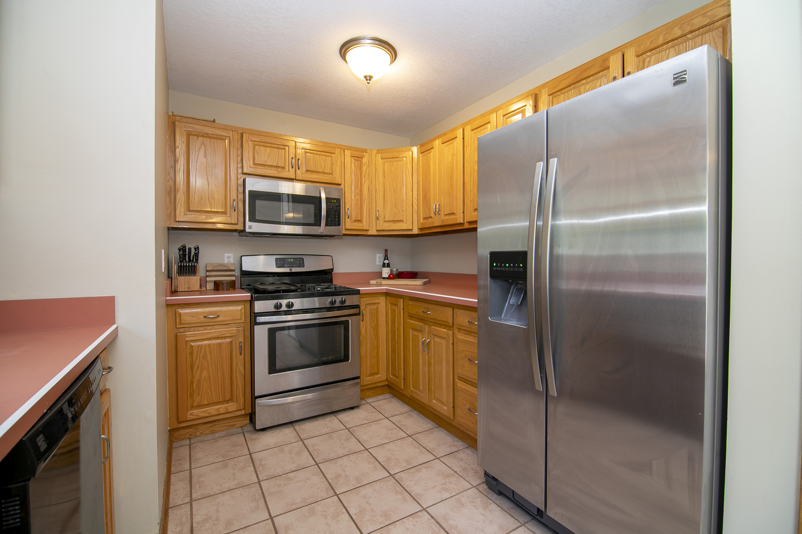 450 South Walnut Street Manteno, IL 60950 - Photo 5 of 14 a kitchen with stainless steel appliances granite countertop a refrigerator a stove a sink and a microwave