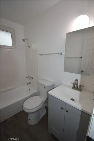 a room with a window and wooden floor