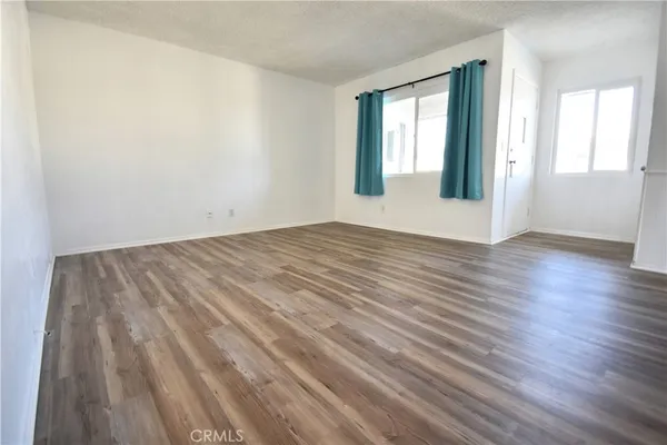 a kitchen with a refrigerator and white cabinets
