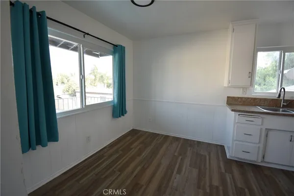 a kitchen with wooden cabinets and white appliances