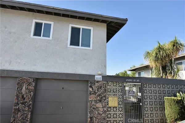 a view of a house with wooden fence