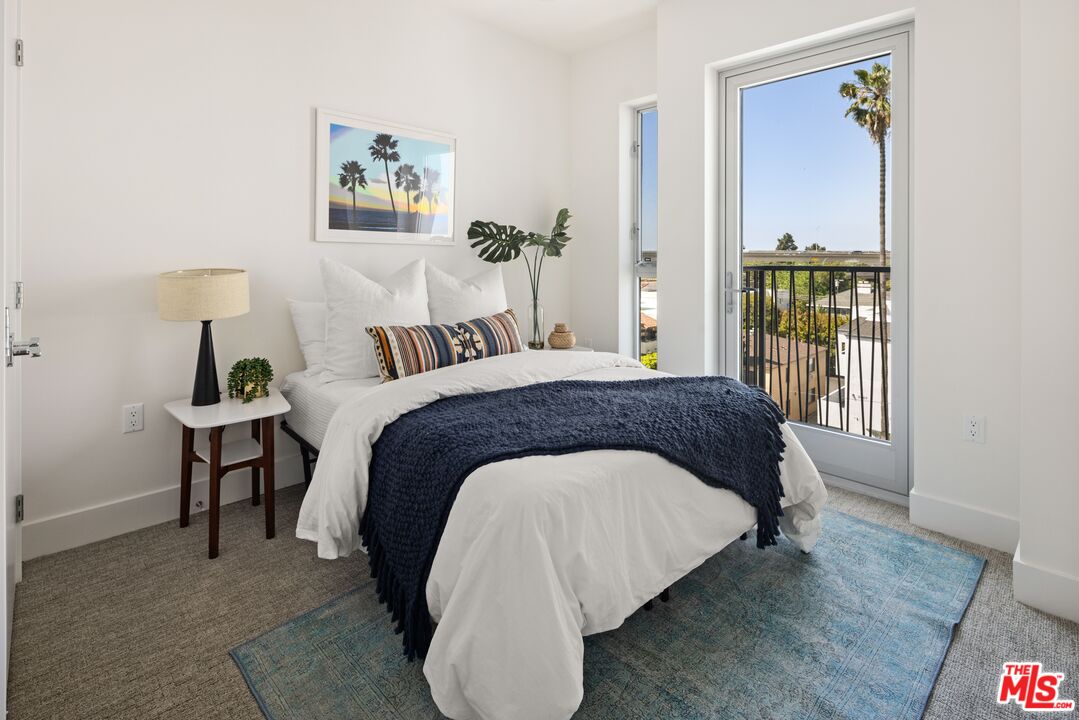 2600 South Sepulveda Boulevard, Unit 407 Los Angeles, CA 90064 - Photo 8 of 33 a spacious bedroom with a bed and a table in it