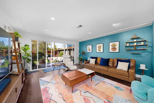 a living room with furniture and a floor to ceiling window