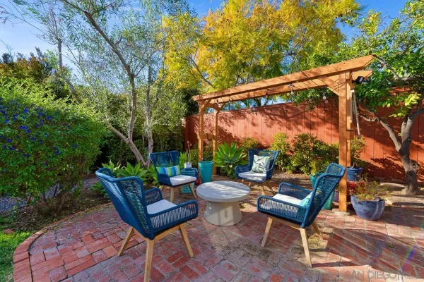 a view of a patio with a table and chairs and couches