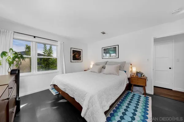 a bedroom with a bed and window
