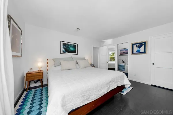 a bedroom with bed and a night stand