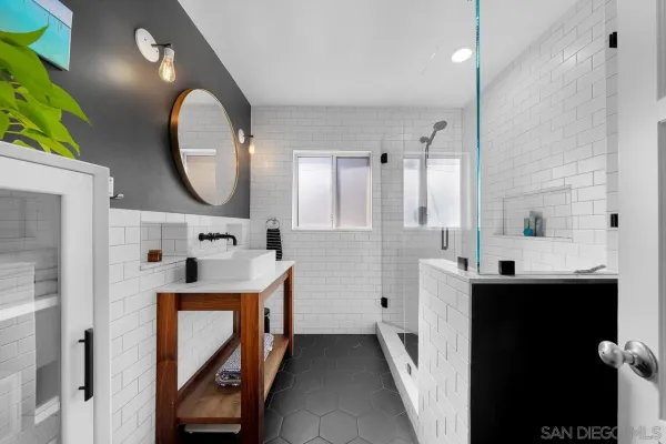 a bathroom with double vanity sink and a mirror