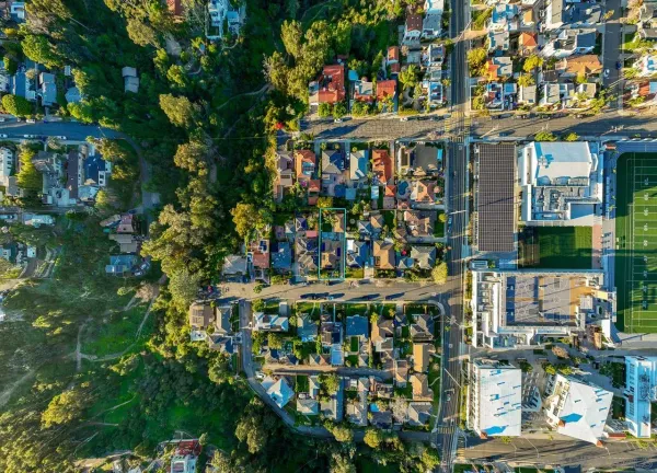 an aerial view of residential houses with city view