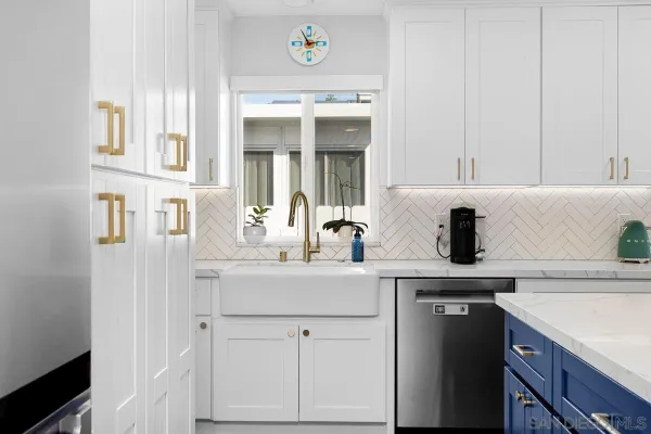 a kitchen with a sink and a refrigerator