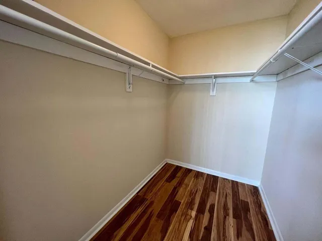 a view of a room with wooden floor