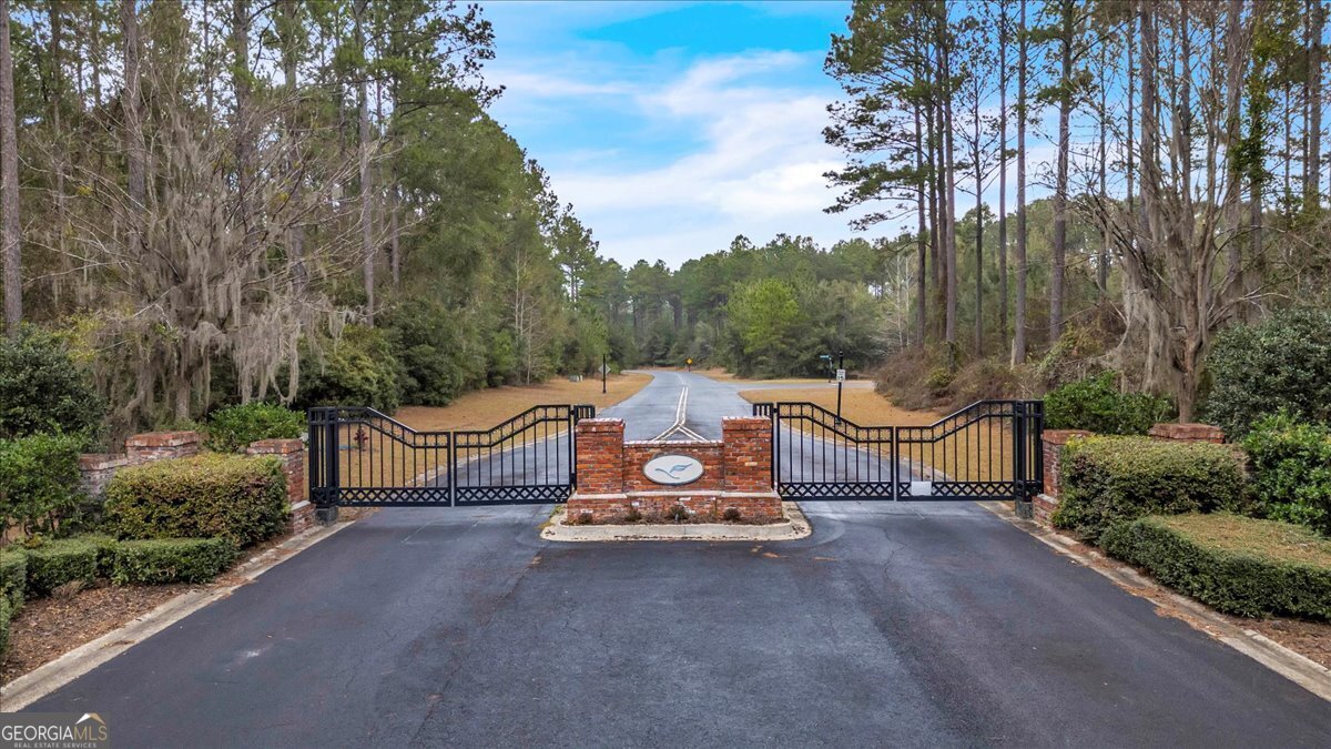Lot 83 Fiddlers Cove Townsend, GA 31331 - Photo 4 of 16 a view of a patio with a table and chairs
