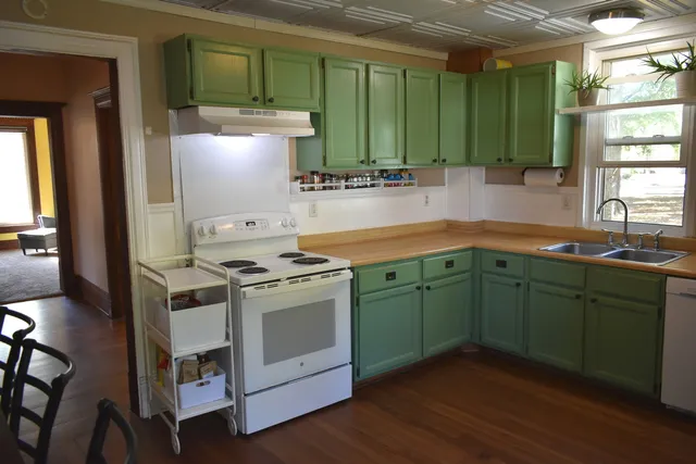 a kitchen with cabinets a sink and a stove