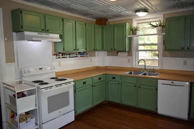 a kitchen with a refrigerator a sink and a window