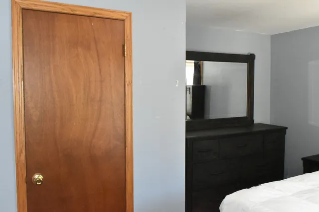 a room with a window and a bed