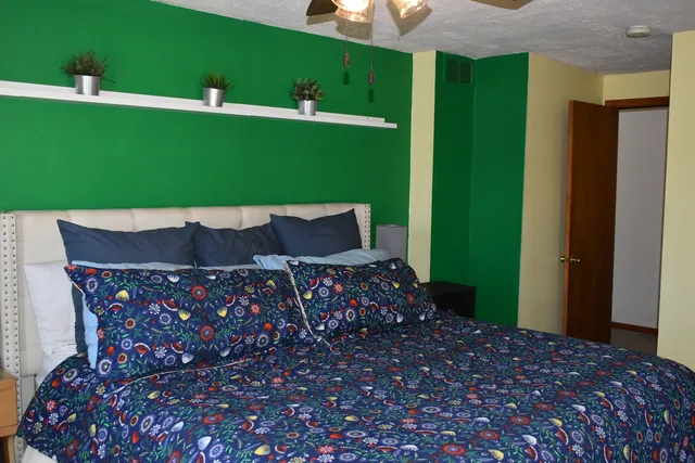 a bedroom with bed and a window