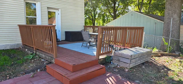 a view of a wooden deck and a yard