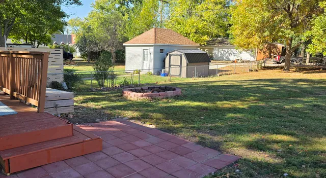a view of a wooden deck and a yard