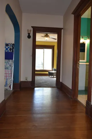 a kitchen with a sink cabinets and a wooden floor