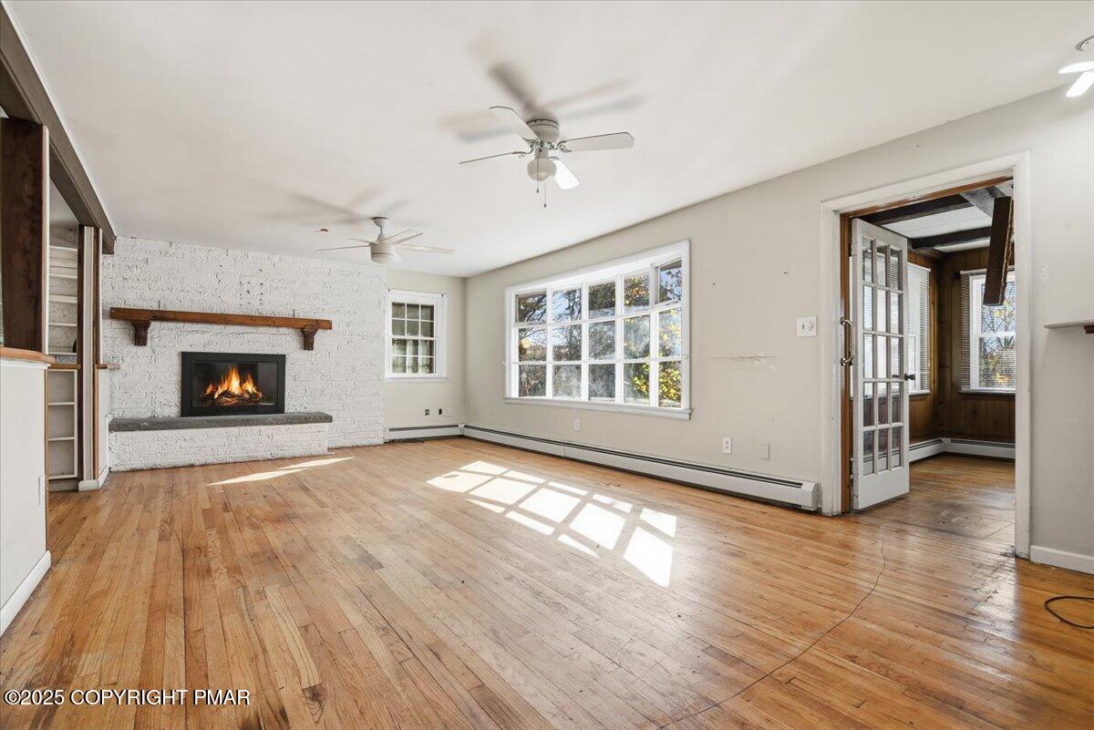 137 Berwick Heights Road East Stroudsburg, PA 18301 - Photo 18 of 88 a view of a livingroom with wooden floor a fireplace and window
