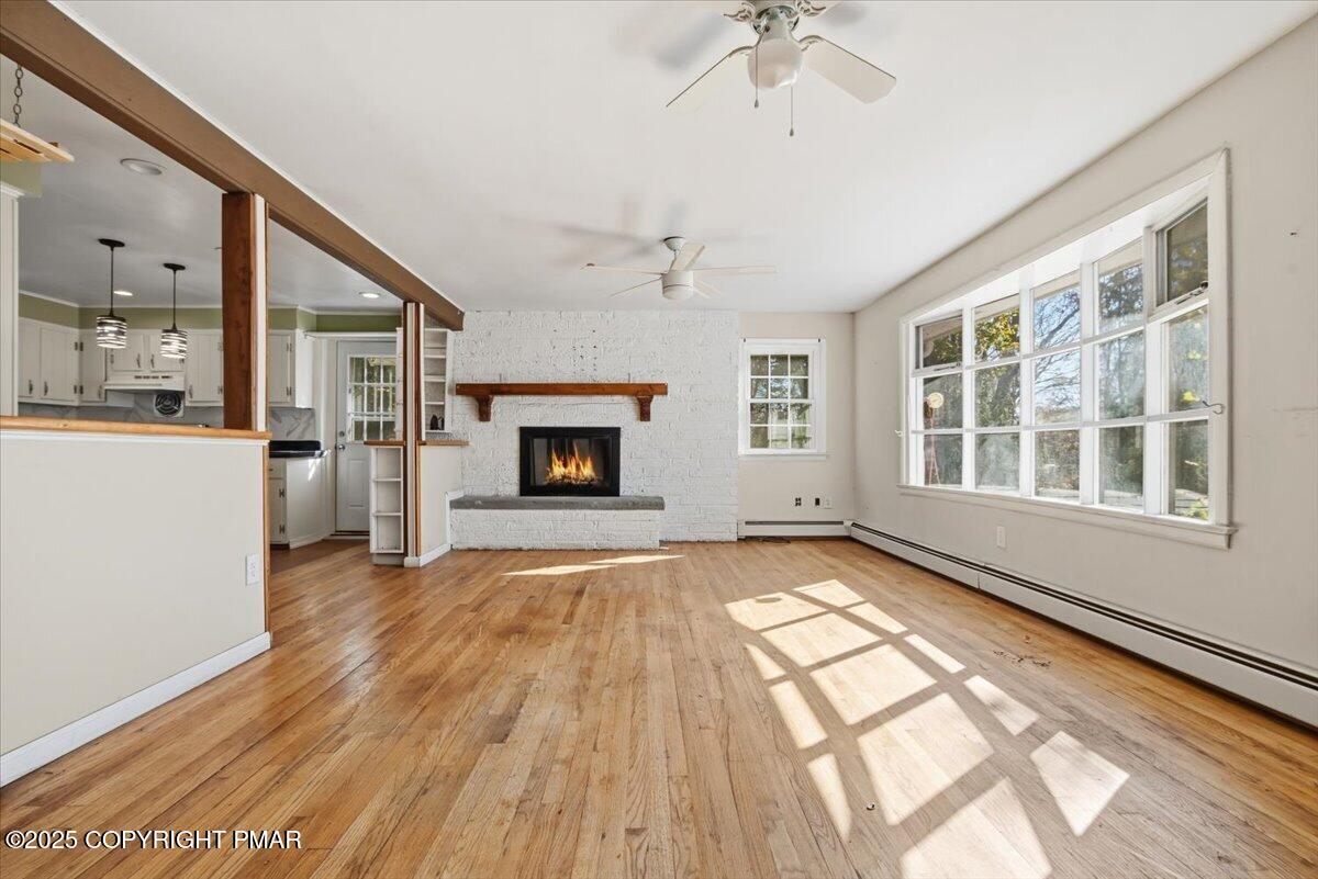 137 Berwick Heights Road East Stroudsburg, PA 18301 - Photo 19 of 88 a view of empty room with a fireplace and wooden floor