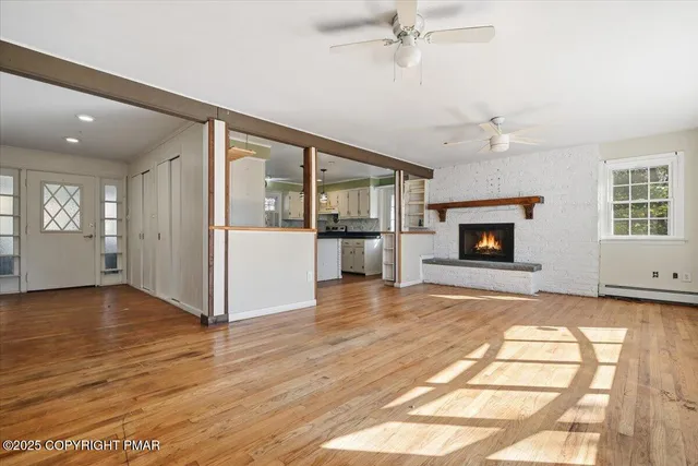a kitchen that has a lot of cabinets in it and wooden floors