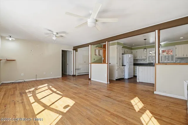 a kitchen with granite countertop white cabinets and a sink