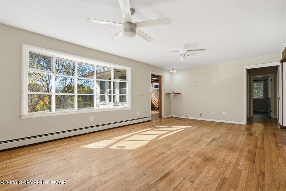 137 Berwick Heights Road East Stroudsburg, PA 18301 - Photo 22 of 88 an empty room with wooden floor and windows