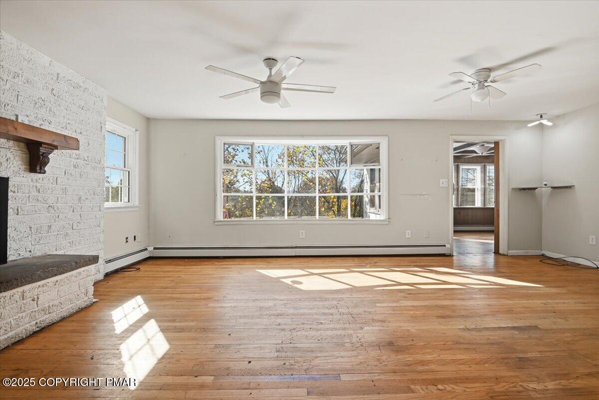 137 Berwick Heights Road East Stroudsburg, PA 18301 - Photo 23 of 88 a view of an empty room with window and wooden floor