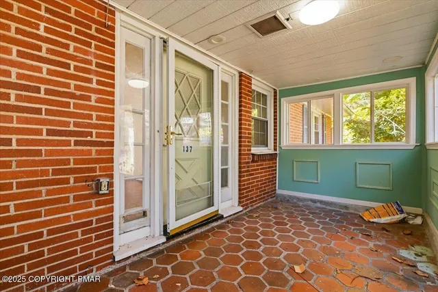 a view of an empty room with a birdcage and a window