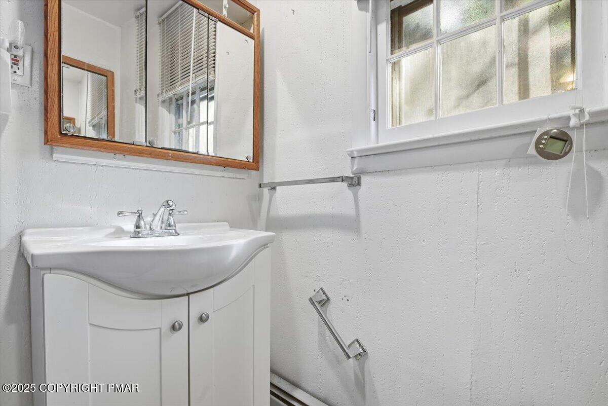 137 Berwick Heights Road East Stroudsburg, PA 18301 - Photo 59 of 88 a bathroom with a sink and a mirror