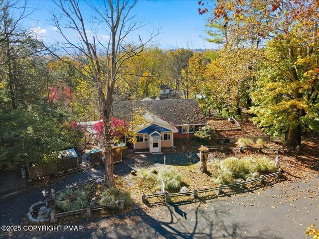 an aerial view of a house with a yard and garden
