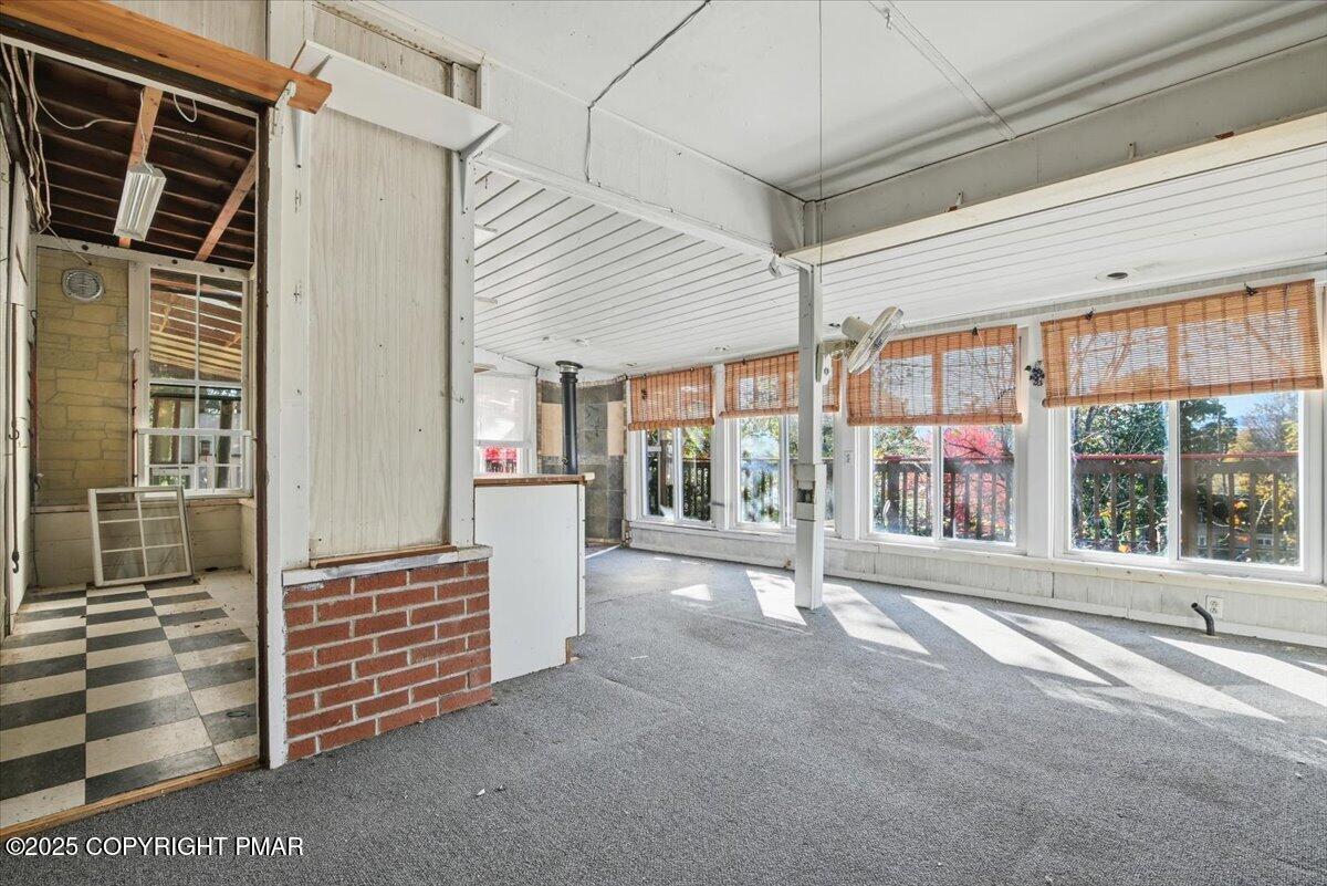 137 Berwick Heights Road East Stroudsburg, PA 18301 - Photo 69 of 88 a view of porch with a table and chairs and floor to ceiling window