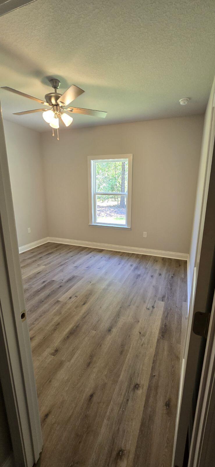 4500 Wolf Track Ridge Crestview, FL 32539 - Photo 15 of 19 en empty room with windows and fan