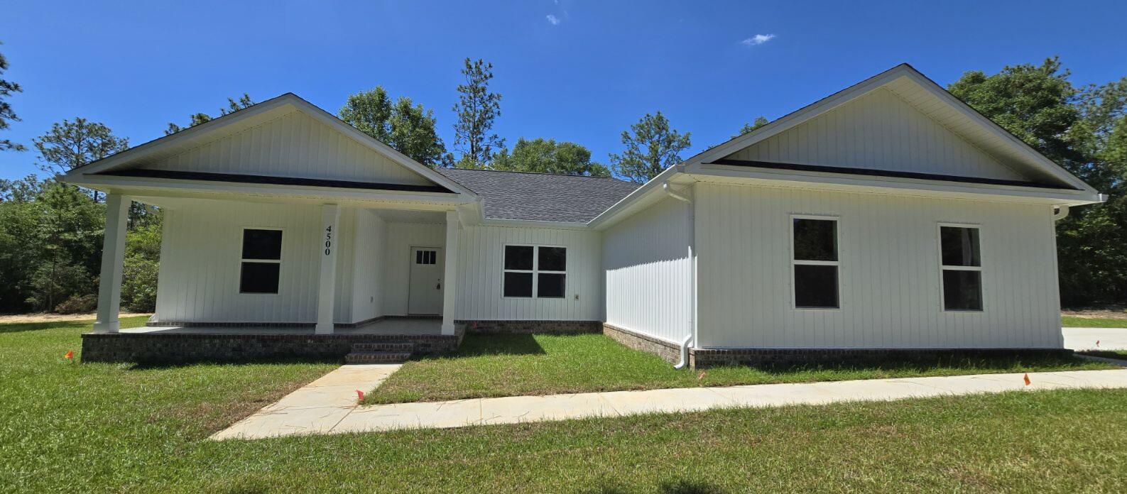 4500 Wolf Track Ridge Crestview, FL 32539 - Photo 2 of 19 a front view of a house with a yard