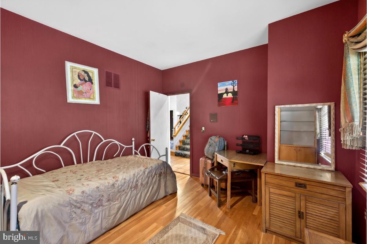 10320 Glen Road Potomac, MD 20854 - Photo 34 of 75 a bedroom with a bed and a table in it