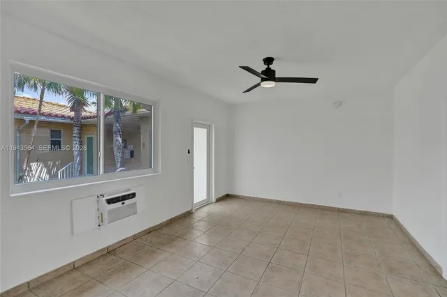 a kitchen with stainless steel appliances white cabinets and a refrigerator
