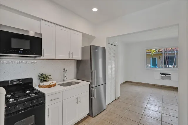 a bathroom with a bathtub a sink a toilet and a mirror