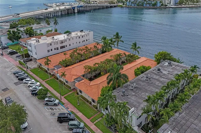an aerial view of a house with a garden and lake view