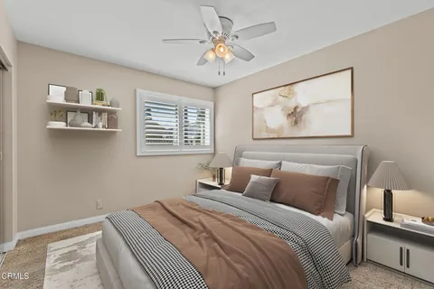 a bedroom with a bed and a potted plant