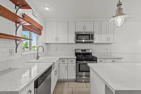 a bathroom with a granite countertop sink toilet and a mirror