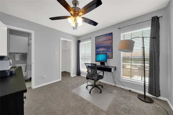 a view of a livingroom with workspace and a window