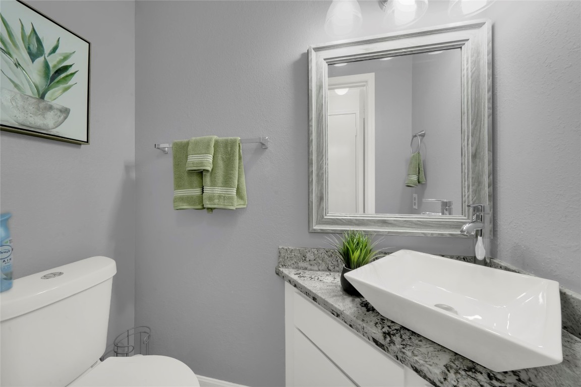 3600 Jeanetta Street, Unit 601 Houston, TX 77063 - Photo 7 of 24 a bathroom with a granite countertop sink mirror vanity and toilet
