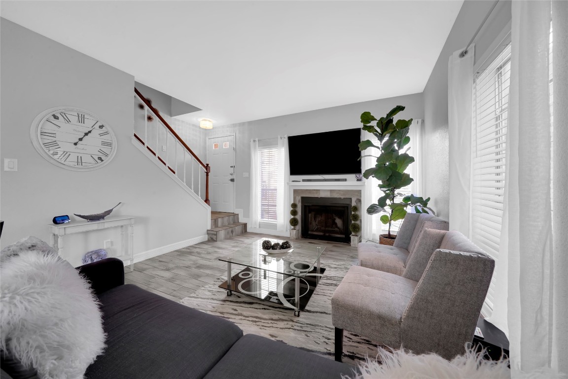 3600 Jeanetta Street, Unit 601 Houston, TX 77063 - Photo 8 of 24 a living room with furniture a fireplace and a flat screen tv