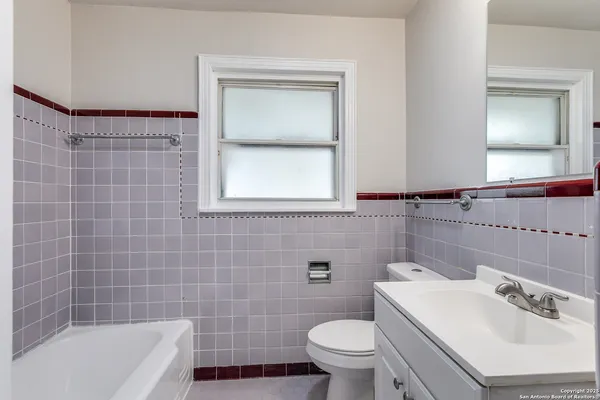 a bathroom with a sink a toilet and bathtub