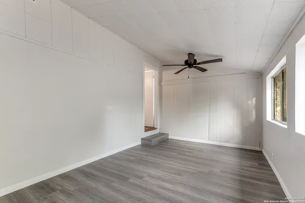 wooden floor in an empty room with a window