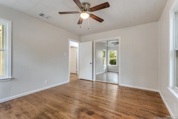 wooden floor in an empty room with a window