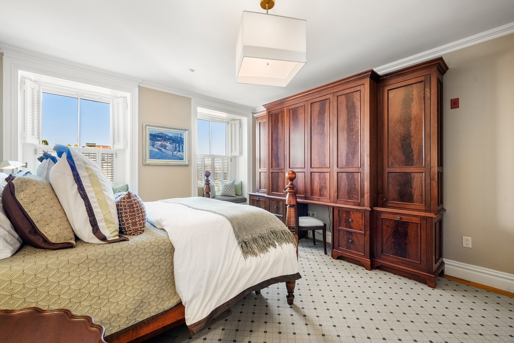 45-47 Commonwealth Avenue, Unit 5 Boston, MA 02116 - Photo 14 of 19 a bedroom with a bed and cabinets