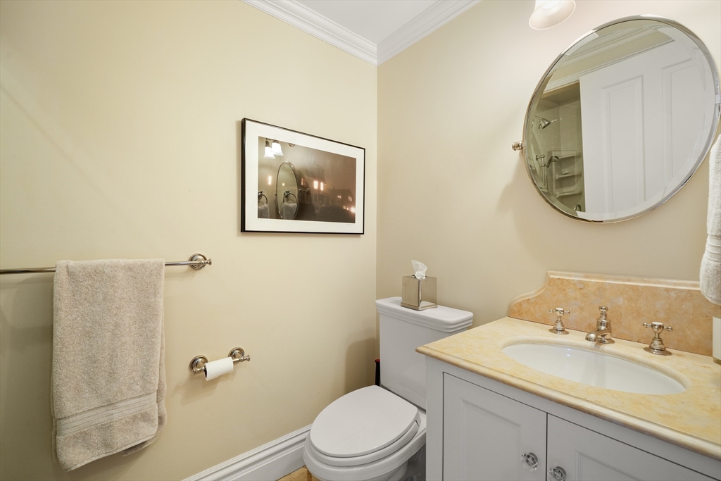 45-47 Commonwealth Avenue, Unit 5 Boston, MA 02116 - Photo 15 of 19 a bathroom with a toilet a sink and mirror