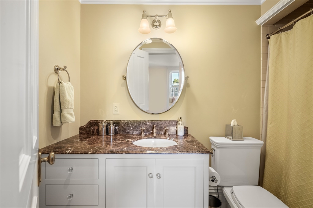 45-47 Commonwealth Avenue, Unit 5 Boston, MA 02116 - Photo 18 of 19 a bathroom with a granite countertop toilet sink and mirror