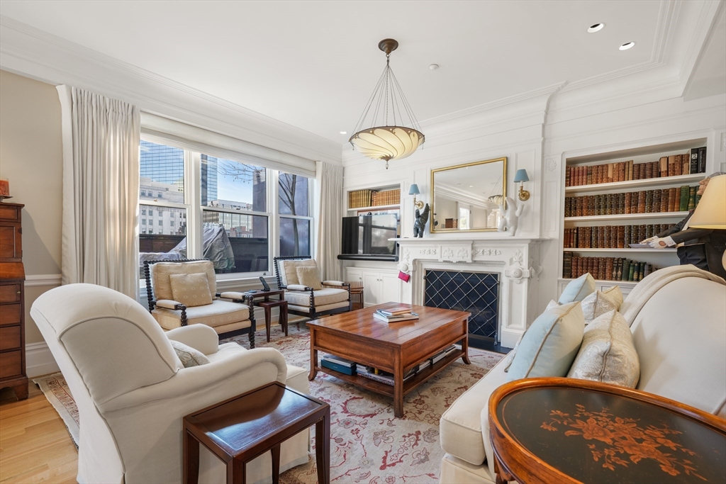 45-47 Commonwealth Avenue, Unit 5 Boston, MA 02116 - Photo 2 of 19 a living room with furniture a fireplace and a chandelier